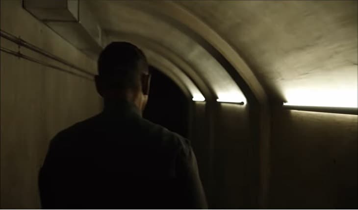 Man walking in dark underground corridor