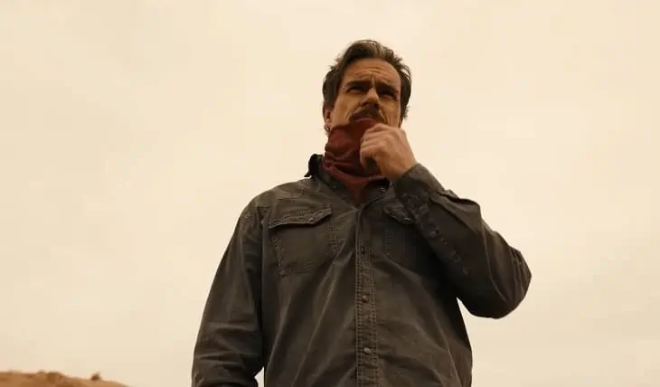 Lalo Salamanca wearing a bandana over his face