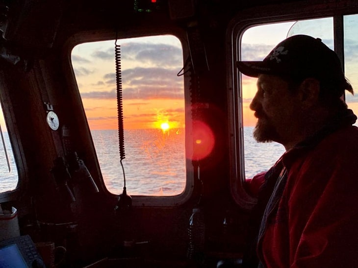 Johnathan Hillstrand at the helm of F/V Time Bandit