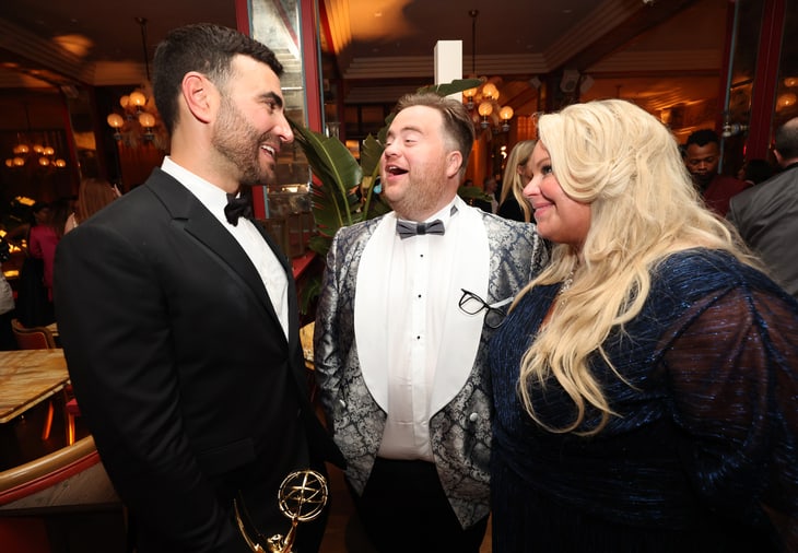 Brett Goldstein, Paul Walter Hauser, and Amy Boland Hauser attend the Apple TV+ Primetime Emmy Reception Red Carpet at Mother Wolf.