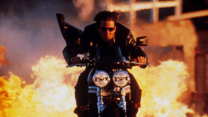 Tom Cruise performing a stunt on a motorcycle in Mission: Impossible II