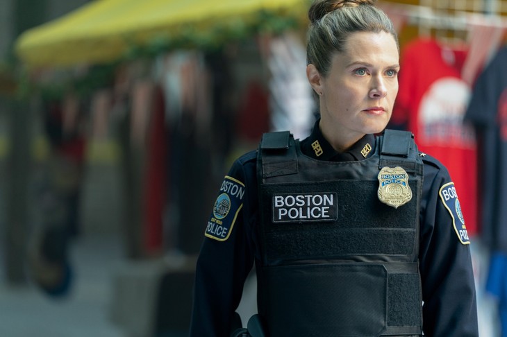Close-up of officer in vest and gloves at outdoor market