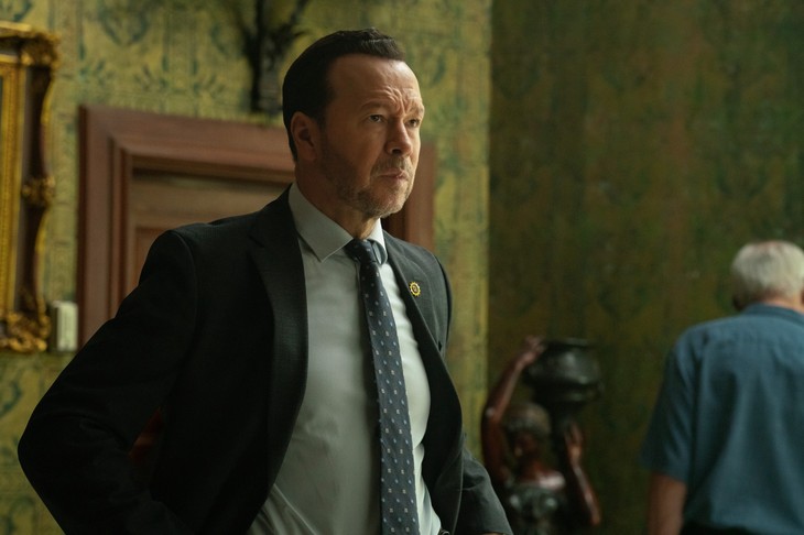 Donnie Wahlberg in suit, focused, in an ornate room